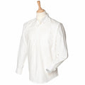 The Henbury HB510 white button-down dress shirt is showcased on a mannequin, featuring long sleeves and a front pocket.