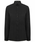 Henbury's HB513 is a plain black button-up shirt featuring long sleeves and a pointed collar, displayed on a white background.