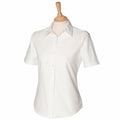 The HB516, a white short-sleeve button-up shirt by Henbury, is displayed on a wooden mannequin stand against a plain background.