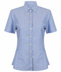 The HB518 by Henbury is a light blue short-sleeve button-up shirt featuring a pointed collar, displayed on a white background.