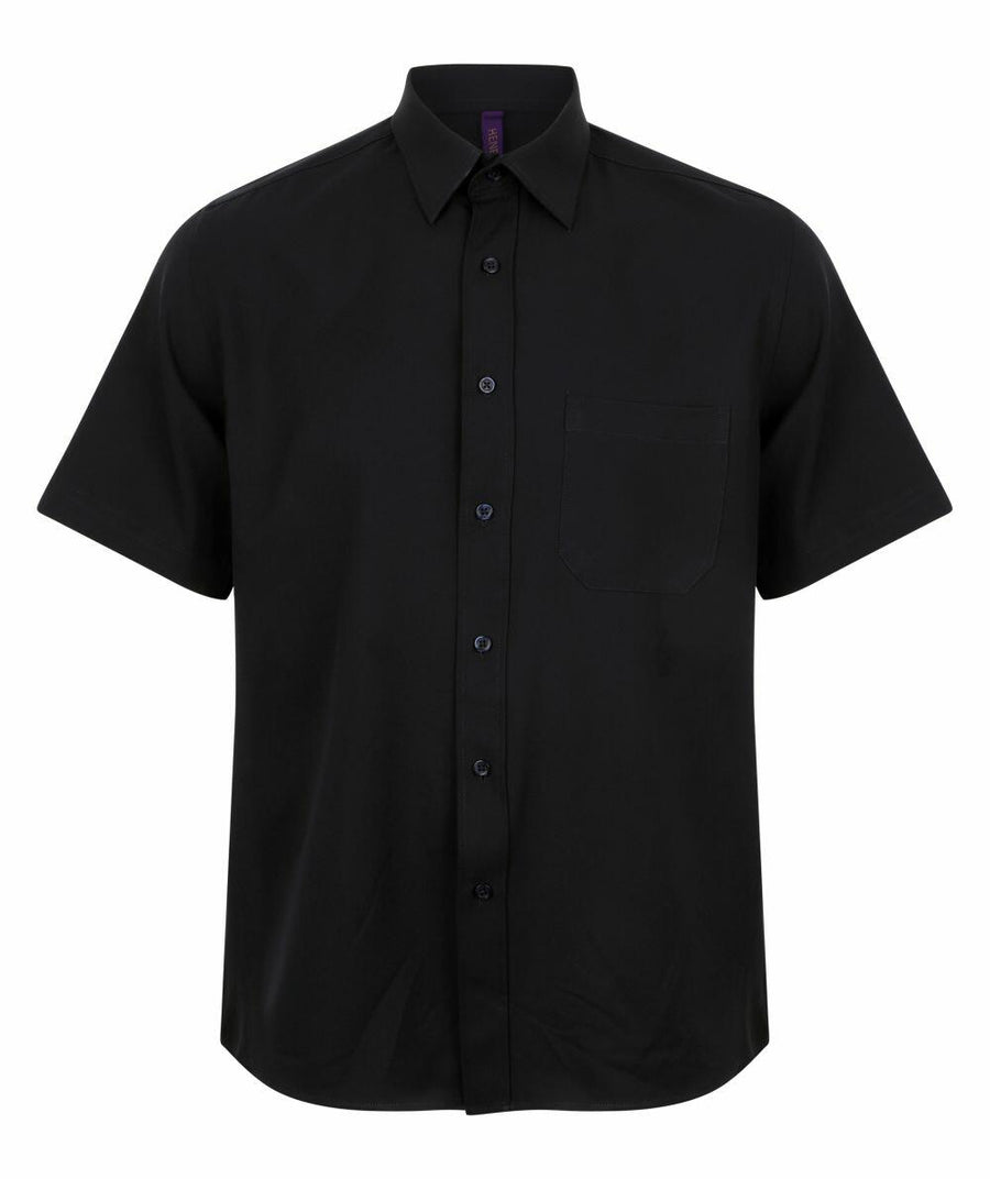 The HB595 from Henbury is a black button-up shirt featuring short sleeves and a front pocket.