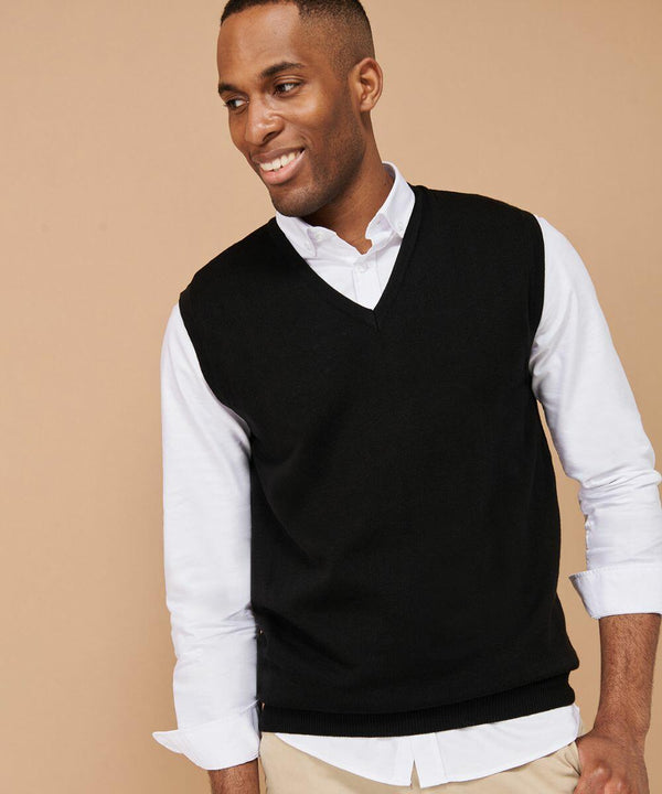 A person wearing a black Henbury HB724 sleeveless sweater over a white shirt, standing against a beige background.