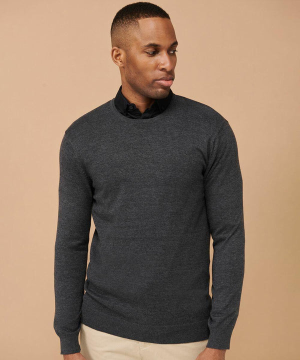 A person wearing a dark gray Henbury HB725 and light-colored pants stands against a plain beige background, looking to the side.