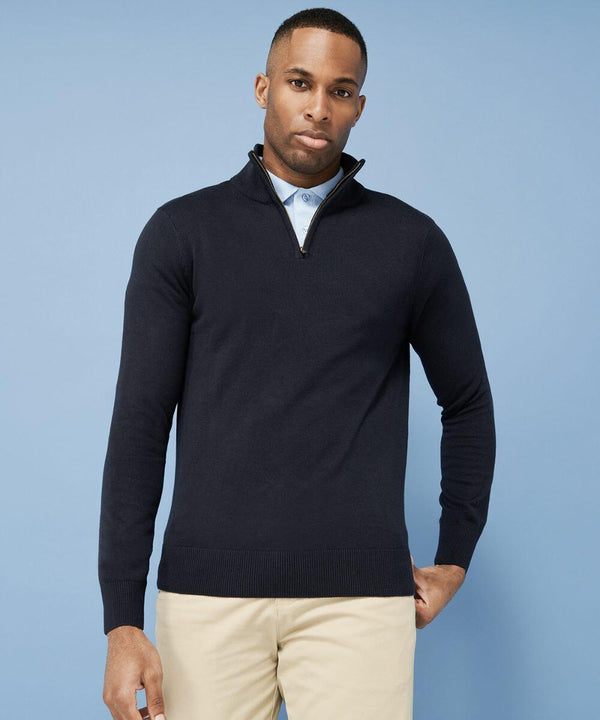 A man in a navy blue Henbury HB729 half-zip sweater and beige pants stands against a light blue background.