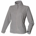 Henbury HB851 is a gray fleece jacket featuring a high collar, front zipper, and two side pockets.