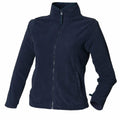 The HB851 by Henbury is a navy blue fleece zip-up jacket with long sleeves and a high collar. This jacket includes two side pockets and features a simple design, making it perfect for casual wear or layering during cooler weather.