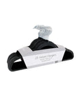 A 25-pack of Home & Living Velvet-effect coat hangers, featuring non-slip and space-saving design, comes stacked with silver hooks in labelled packaging reading "25 Velvet Hangers, Strong & Durable.