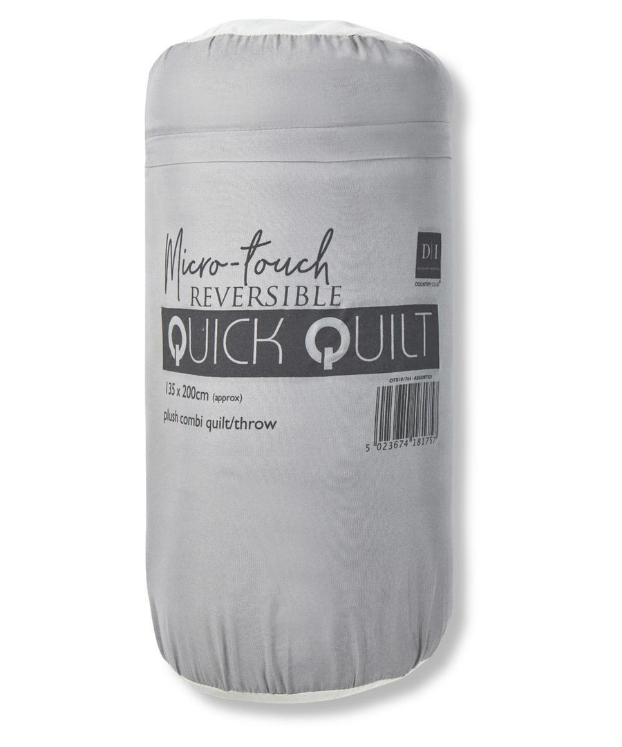 A rolled, light grey packaged blanket labelled "Blankets," approx. 135 x 200 cm, described as a plush combi quilt/throw. A barcode is visible on the packaging.