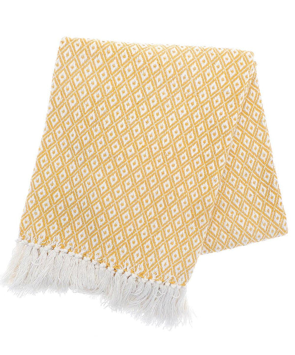 A folded blanket in yellow and white with a diamond pattern and white fringe on one edge, shown against a plain white background.