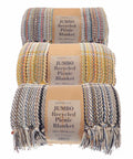Three rolled jumbo recycled picnic blankets from the brand Home & Living, each featuring various multicolored patterns and fringed edges, labeled with product name HL207 and dimensions of 180 x 250cm.