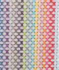 A close-up image of the Home & Living HL212 textile showcases a checkered pattern featuring a vibrant combination of colors including blue, green, purple, pink, orange, and red arranged in vertical stripes.