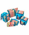 A set of six blue travel bags with multicolored striped accents, including a backpack, tote, cooler bags, and foldable bags, displayed against a white background. The set is the HL221 from Home & Living.