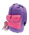 A large purple rucksack from Bags, featuring a pink front pocket, is placed next to pink high-top trainers with white laces and soles on a white background.