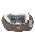 A round, grey Dog Bed featuring a soft, plush white and grey interior. The textured outer fabric includes an attached label with product information. The empty bed is displayed on a white background.