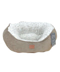 The Dog Beds product features a round, plush design with a soft grey exterior, white fluffy inner lining, small brown front label, and a side product tag.