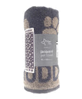 A rolled-up Dog Towel (90x165 cm) with a paw print jacquard design and product label, displayed on a plain white background.
