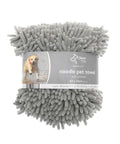 A rolled-up grey Dog Towel with pockets is wrapped in branded packaging. The label features a dog running through water and highlights its super absorbency, quick drying, and soft material.