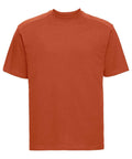 A simple, short-sleeved orange t-shirt on a white background, featuring a classic round neckline. This design is from the Russell brand, model J010M.