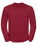 The Russell J013M is a plain, long-sleeved red sweatshirt featuring a crew neck, set against a white background. Its design is simple and free of logos or patterns.