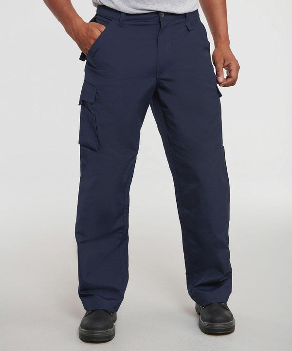 Man wearing navy blue cargo pants, a grey t-shirt, and Russell J015M black shoes, with hands in pockets.