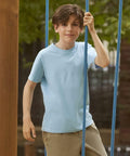 A boy in a light blue T-shirt and beige pants holds onto a blue Russell J180B outside.
