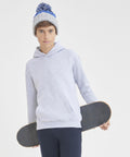A young person wearing a gray hoodie and knitted hat holds a Russell J201J skateboard.