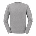 A Russell J262M gray crewneck sweatshirt is displayed on a plain white background. The fabric looks soft and comfortable, featuring long sleeves and ribbed cuffs. Its simple, unadorned design makes it ideal for casual wear.