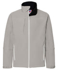 The Russell J410M is a light gray, zip-up softshell jacket featuring a high collar and multiple pockets. This stylish piece includes a front zipper, two side zipper pockets, and one chest pocket, making it perfect for both casual and outdoor wear.