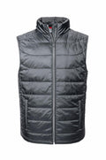 Presenting the Russell J441M, a sleeveless puffer vest in dark gray equipped with a zippered front and high collar for cold weather protection. The vest features horizontal stitching and includes two convenient side pockets.