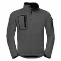Introducing the J520M by Russell: A men's jacket in gray, designed with a high collar and multiple zippered pockets. It boasts a sleek look featuring two vertical chest pockets and two side pockets. Crafted from softshell material, it's ideal for outdoor activities.