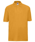 Introducing the Russell J539B: a mustard yellow polo shirt featuring a short-sleeve design and a classic collar. It has a button-up placket with two visible buttons, showcased against a white background.