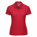 The Russell J539F is a plain red polo shirt featuring short sleeves and a collar, displayed against a white background.