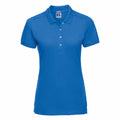 The product image showcases a plain blue polo shirt, model J566F by Russell, featuring short sleeves and a buttoned collar against a white background.