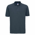 The Russell J569M is a dark green polo shirt featuring short sleeves, a collar, and a small logo tag at the neck.