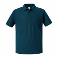 A Russell J570M dark green short-sleeve polo shirt, featuring a classic collar and three-button placket, displayed on a plain white background.