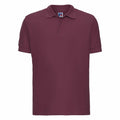 A plain maroon short-sleeve polo shirt with a collar, identified as the Russell J577M, displayed against a white background.