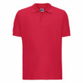 Russell's J577M is a red polo shirt featuring a collar and short sleeves, with a sleek, plain appearance free of any visible designs or patterns.