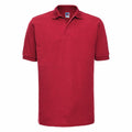 A Russell J599M polo shirt in plain red, featuring short sleeves and a classic collar, displayed on a white background.