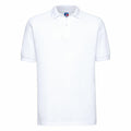 The Russell J599M is a white polo shirt with a simple, classic design, featuring a collar, short sleeves, and a two-button placket. The fabric is smooth and lightweight.