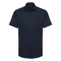 The Russell Collection's J923M is a navy blue shirt with short sleeves, a button-up front, and a collar.