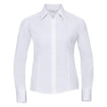 The Russell Collection's J924F is a white long-sleeved button-up shirt featuring a pointed collar, set against a plain white background. The shirt showcases smooth and tailored fabric with cuffs at each sleeve end.