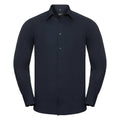 A long-sleeved, dark navy button-up shirt from the Russell Collection, model J924M, featuring a classic collar and cuffed sleeves is displayed against a white background. The shirt is neatly pressed and has a slim-fitting style.