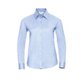 A light blue, long-sleeved button-up shirt with a classic collar from the Russell Collection, model J932F, displayed against a white background.