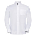 Introducing the Russell Collection's J932M: a crisp white button-up shirt featuring a pointed collar and long sleeves. This elegant design includes a left-side chest pocket and buttoned cuffs, all meticulously pressed and showcased against a pristine white background.