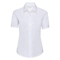 A white, short-sleeved button-up shirt from the Russell Collection, product J933F, is displayed on a plain background. The shirt showcases a classic collar and a fitted design, ideal for formal or office wear.