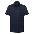 Russell Collection's J933M is a navy blue short-sleeve button-up shirt featuring a chest pocket, showcased against a white background.
