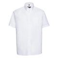 A short-sleeved button-up shirt in white, featuring a pointed collar and a chest pocket from the Russell Collection's J933M line, displayed against a plain white background.