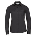 The J934F, a black long-sleeved button-up shirt featuring a collar and chest pocket from the Russell Collection, is displayed against a plain white background.