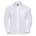 The J934M, a dress shirt from Russell Collection, features a plain white long-sleeve design with a button-up front and a single breast pocket. It includes a classic collar and cuffs and is showcased against a white background.