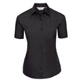 The J935F from the Russell Collection is a black, short-sleeve, button-up shirt featuring a collar and a chest pocket, displayed against a white background.
